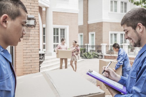 Removal team using safe lifting methods during a move
