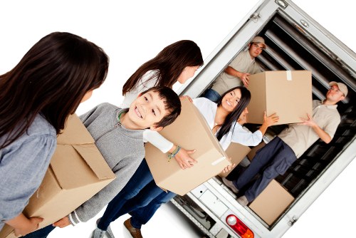 Removal team handling a house move in Kentish Town street setting