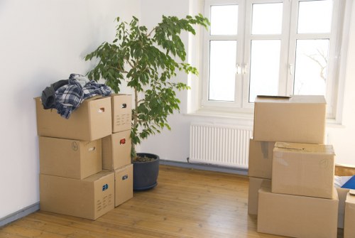 Professional removal team handling boxes in Kentishtown