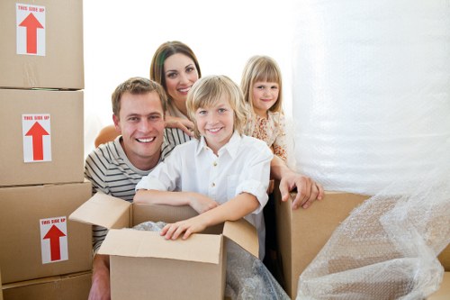 Professional movers packing fragile belongings carefully