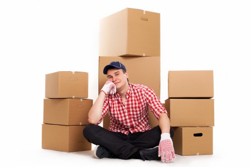 Movers handling boxes and furniture during urgent relocation in Kentishtown